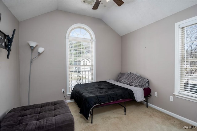 carpeted bedroom featuring a ceiling fan, baseboards, and vaulted ceiling