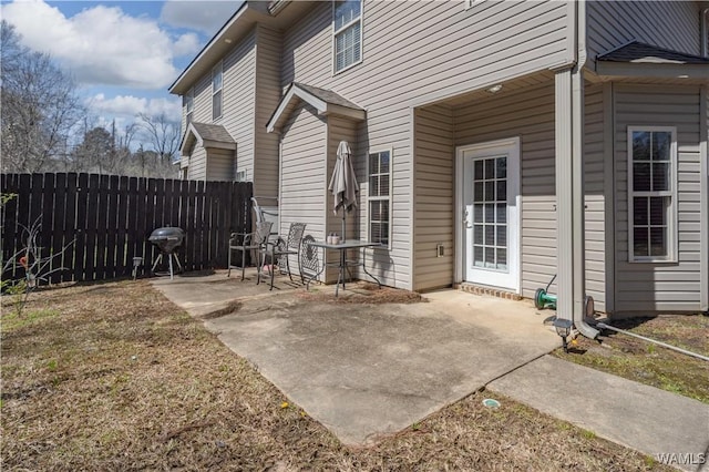 view of patio featuring area for grilling and fence