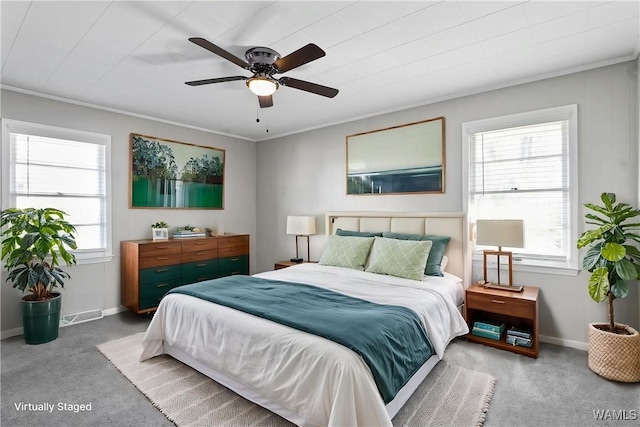 carpeted bedroom featuring baseboards, ornamental molding, and ceiling fan