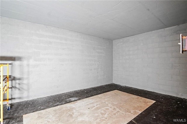 spare room with concrete block wall