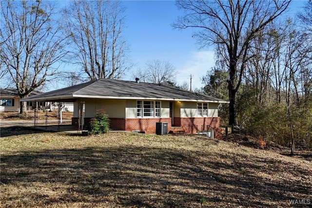 exterior space with an attached carport and brick siding