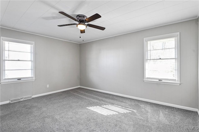 unfurnished room featuring carpet floors, crown molding, and a healthy amount of sunlight