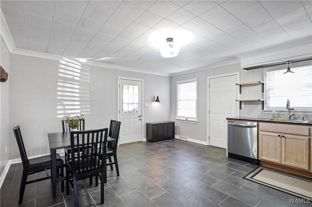 dining space with ornamental molding and sink