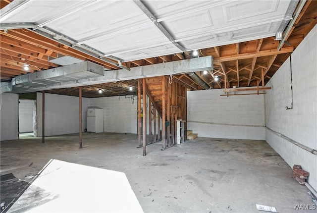 basement with white refrigerator