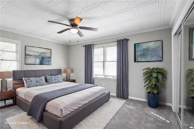 carpeted bedroom featuring crown molding, baseboards, and ceiling fan