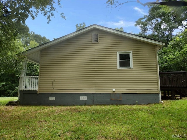 view of side of home featuring a lawn