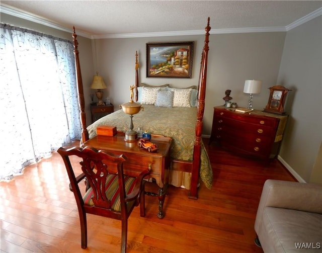 bedroom featuring ornamental molding and hardwood / wood-style flooring