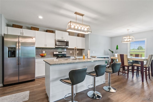 320 Rob Lee St, Moundville, AL 35474 - kitchen featuring stainless steel appliances, dark wood-style floors, backsplash, white cabinets, and light stone counters