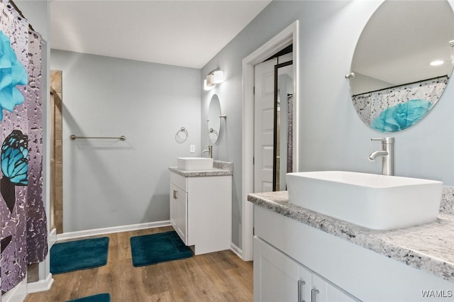 320 Rob Lee St, Moundville, AL 35474 - bathroom with wood finished floors, two vanities, and a shower with shower curtain