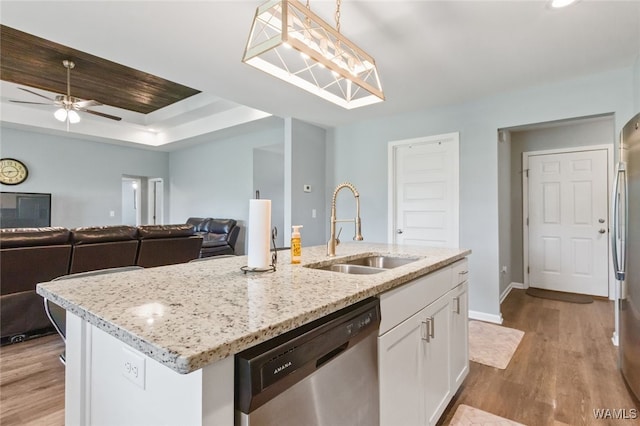 320 Rob Lee St, Moundville, AL 35474 - kitchen featuring appliances with stainless steel finishes, white cabinetry, light wood-style flooring, and an island with sink