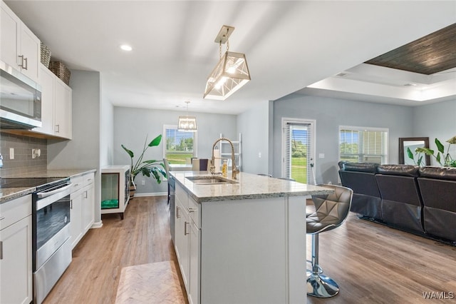 320 Rob Lee St, Moundville, AL 35474 - kitchen with stainless steel appliances, light wood-style flooring, open floor plan, recessed lighting, and plenty of natural light