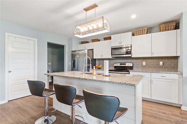320 Rob Lee St, Moundville, AL 35474 - kitchen featuring stainless steel appliances, decorative backsplash, and light wood-type flooring