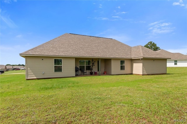 320 Rob Lee St, Moundville, AL 35474 - rear view of house featuring a yard, a shingled roof, and a patio