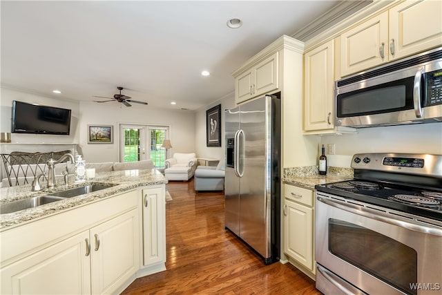 kitchen with crown molding, sink, dark hardwood / wood-style floors, ceiling fan, and appliances with stainless steel finishes