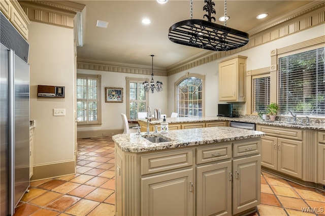 kitchen featuring crown molding, a kitchen island, a healthy amount of sunlight, and decorative light fixtures