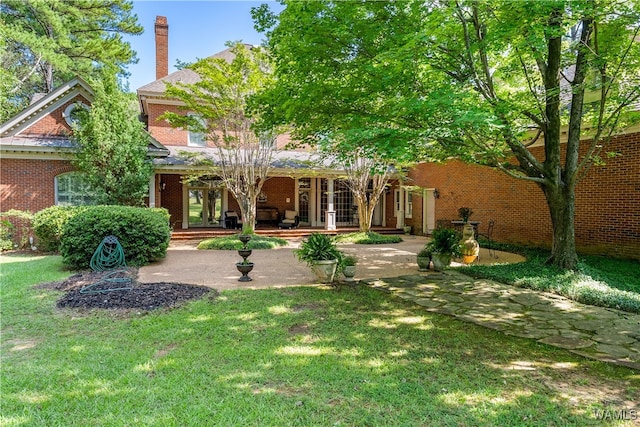 back of property featuring a lawn and a porch