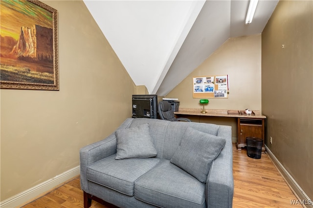 living area with lofted ceiling and light wood-type flooring