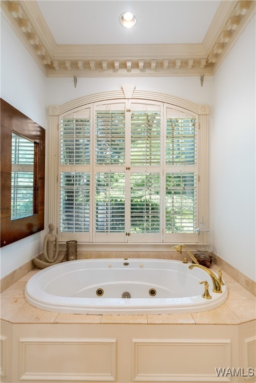 bathroom featuring plenty of natural light, ornamental molding, and a tub to relax in