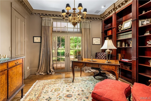 office featuring french doors, light hardwood / wood-style flooring, crown molding, and a notable chandelier