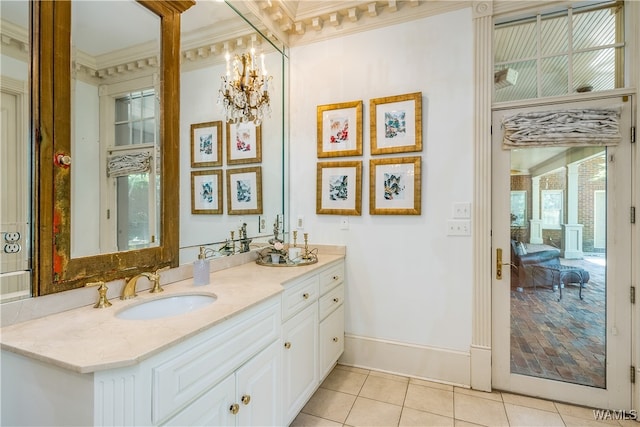 bathroom with a chandelier, vanity, ornamental molding, and tile patterned flooring