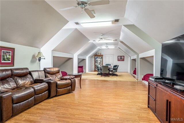 living room featuring lofted ceiling, ceiling fan, and light wood-type flooring