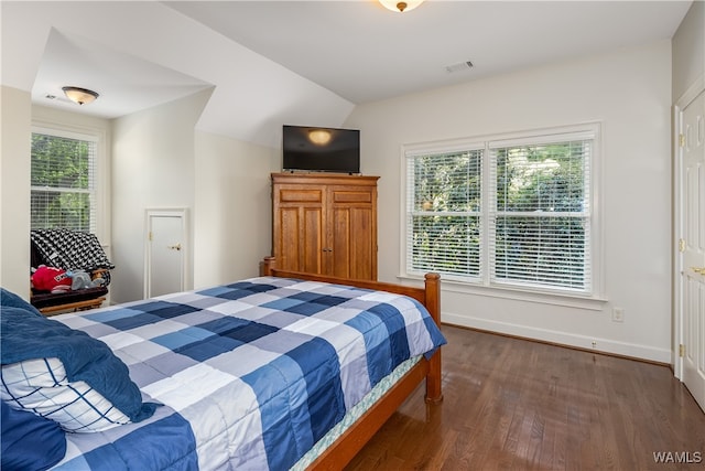 bedroom featuring dark hardwood / wood-style flooring and vaulted ceiling