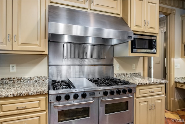 kitchen with light stone countertops and appliances with stainless steel finishes