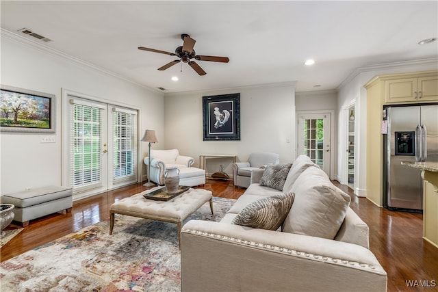 living room featuring a wealth of natural light, dark hardwood / wood-style flooring, and ornamental molding