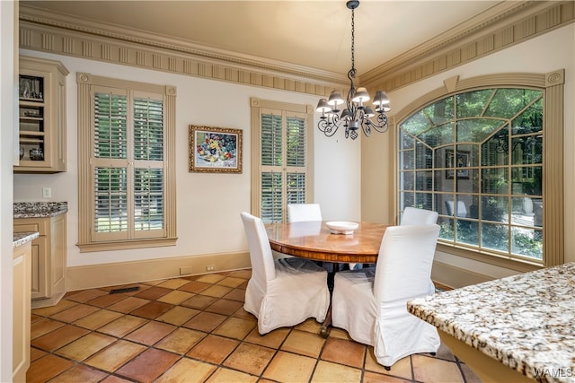 dining space featuring an inviting chandelier, plenty of natural light, and crown molding