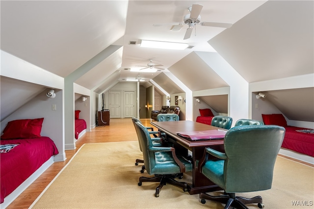 interior space featuring ceiling fan, light wood-type flooring, and vaulted ceiling