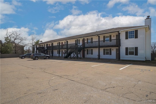 view of property featuring uncovered parking