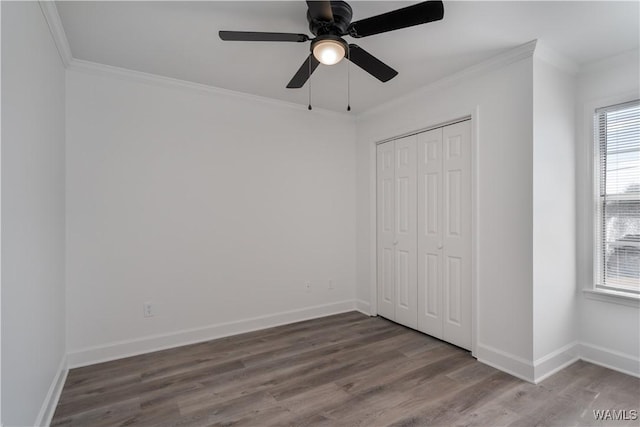 unfurnished bedroom featuring ornamental molding, wood finished floors, and baseboards