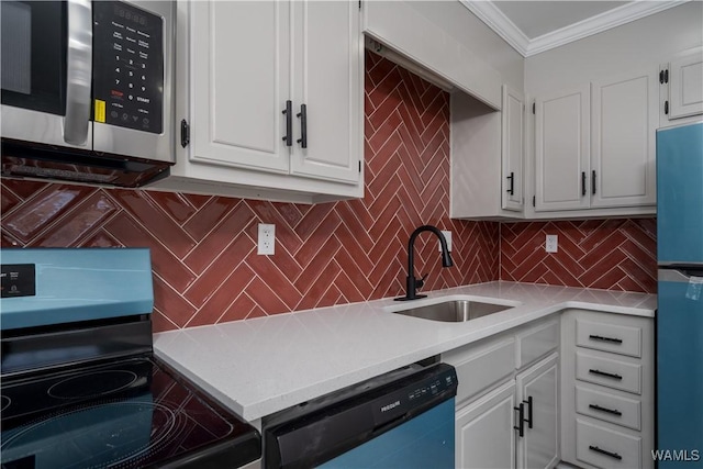 kitchen with crown molding, stainless steel appliances, light countertops, white cabinets, and a sink