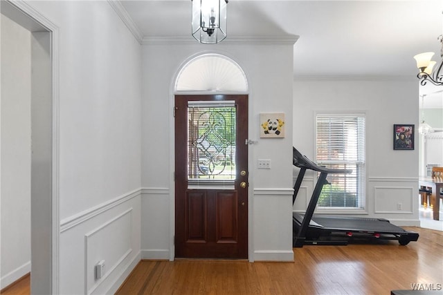 839 Seven Oaks Pl, Tuscaloosa, AL 35406 - entrance foyer featuring a chandelier, wood finished floors, wainscoting, ornamental molding, and a decorative wall
