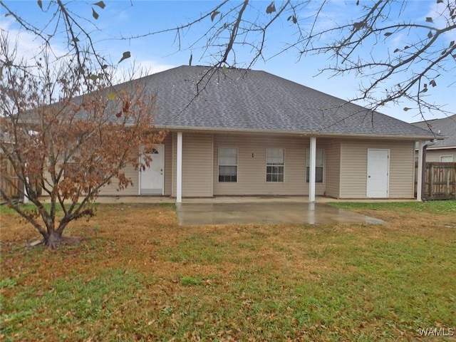 back of house featuring a patio area and a lawn