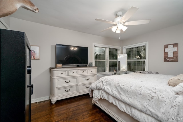 bedroom with ceiling fan and dark wood-type flooring