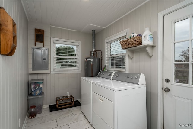 laundry room with wooden walls, gas water heater, electric panel, and washing machine and clothes dryer