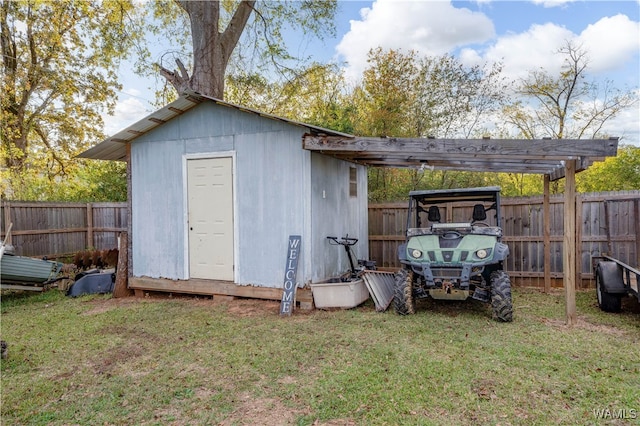 view of outbuilding featuring a yard