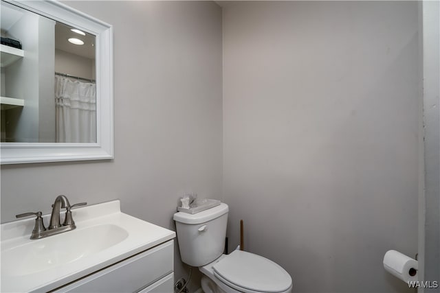 bathroom featuring vanity and toilet