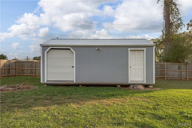 view of outbuilding with a yard