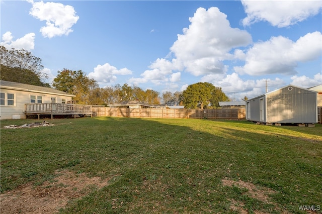 view of yard with a deck and a storage unit