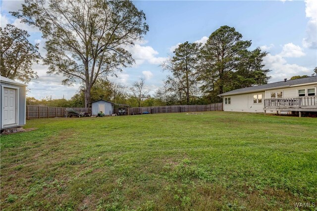 view of yard with a storage shed and a wooden deck