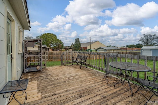 wooden deck with a lawn