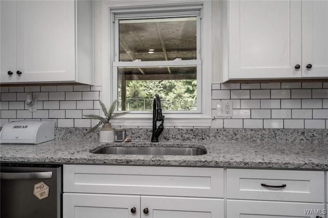 15120 Lakeland Forest Dr, Northport, AL 35475 - kitchen featuring dishwashing machine, a sink, white cabinetry, and tasteful backsplash
