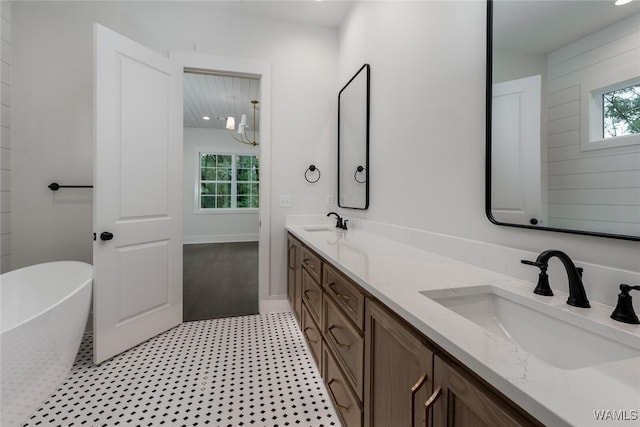 14817 Highpoint Cv, Northport, AL 35475 - bathroom featuring double vanity, a freestanding bath, and tile patterned floors