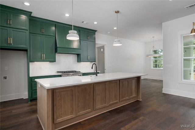 14817 Highpoint Cv, Northport, AL 35475 - kitchen with green cabinetry, dark wood-type flooring, light countertops, premium range hood, and a center island with sink