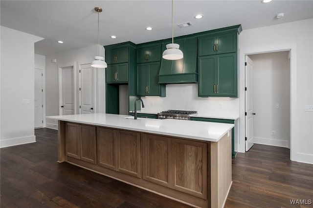 14817 Highpoint Cv, Northport, AL 35475 - kitchen with green cabinetry, dark wood-style flooring, light countertops, a kitchen island with sink, and recessed lighting