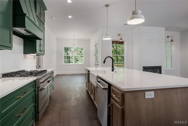 14817 Highpoint Cv, Northport, AL 35475 - kitchen featuring appliances with stainless steel finishes, green cabinetry, premium range hood, dark wood-style floors, and light countertops