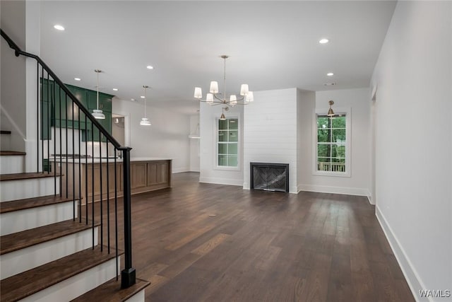 14817 Highpoint Cv, Northport, AL 35475 - unfurnished living room featuring dark wood-style flooring, stairs, a chandelier, recessed lighting, and a large fireplace