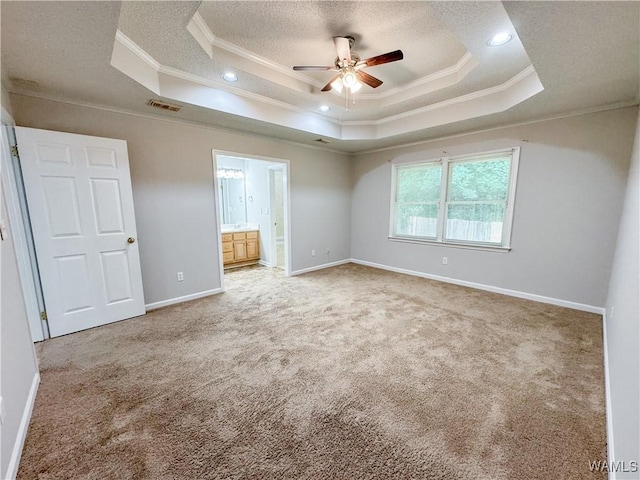 unfurnished bedroom featuring a tray ceiling, crown molding, and ceiling fan